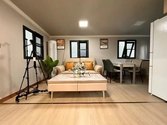 Inviting living and dining space in prefab homes NZ and compac homes, showcasing contemporary portable cabin interiors