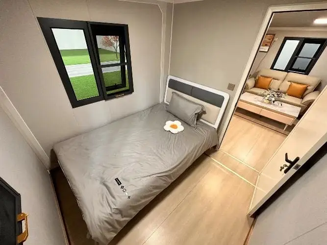 Cozy bedroom layout in prefab home, highlighting compact design ideal for portable cabins in NZ.