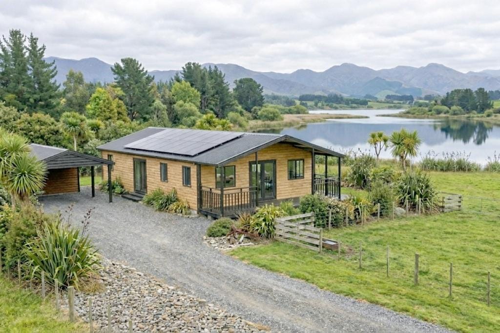 Off-grid expandable home with solar beside a lake
